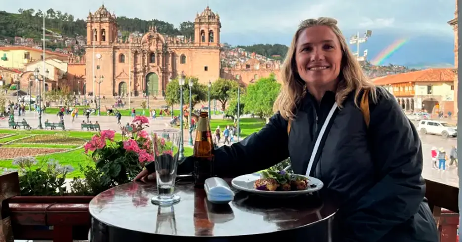 Tourist eating with a view of Cusco's Plaza de Armas