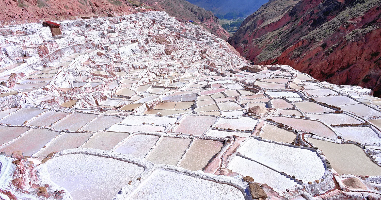 Panoramic view of the white salt evaporation ponds at Maras Salt Mines in the Sacred Valley of Peru