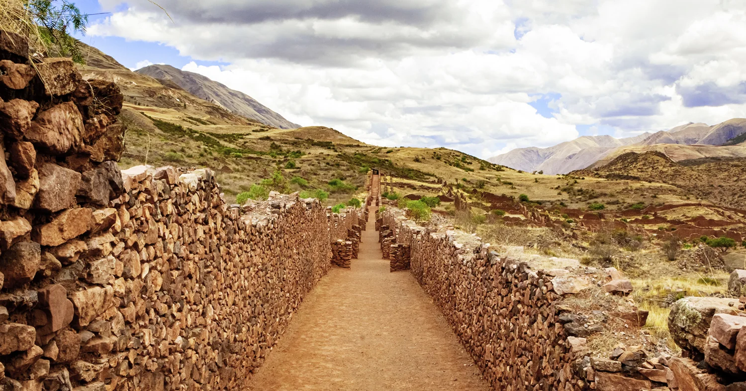 Stone pathway between ancient walls at Pikillacta archaeological site near Cusco, Peru