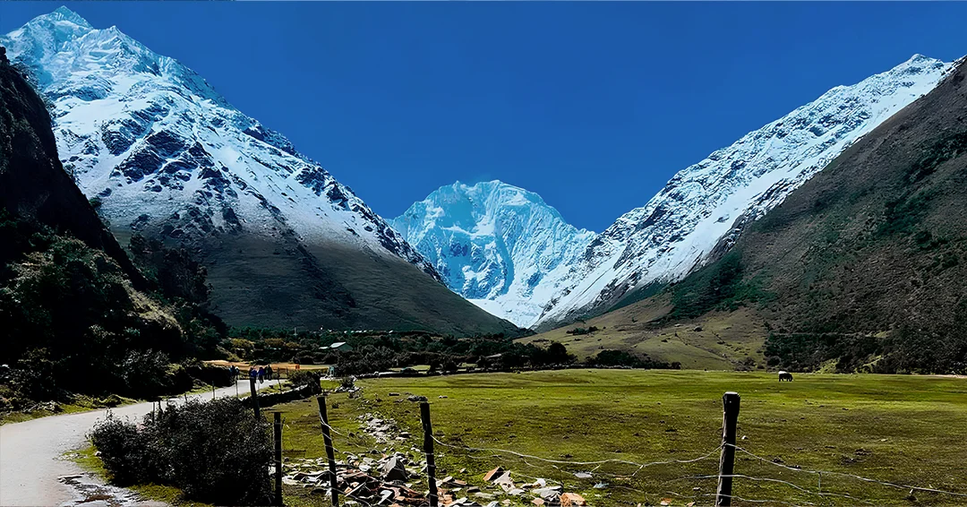 Hikers following a mountain trail beside a stream on the Salkantay Trek in Peru