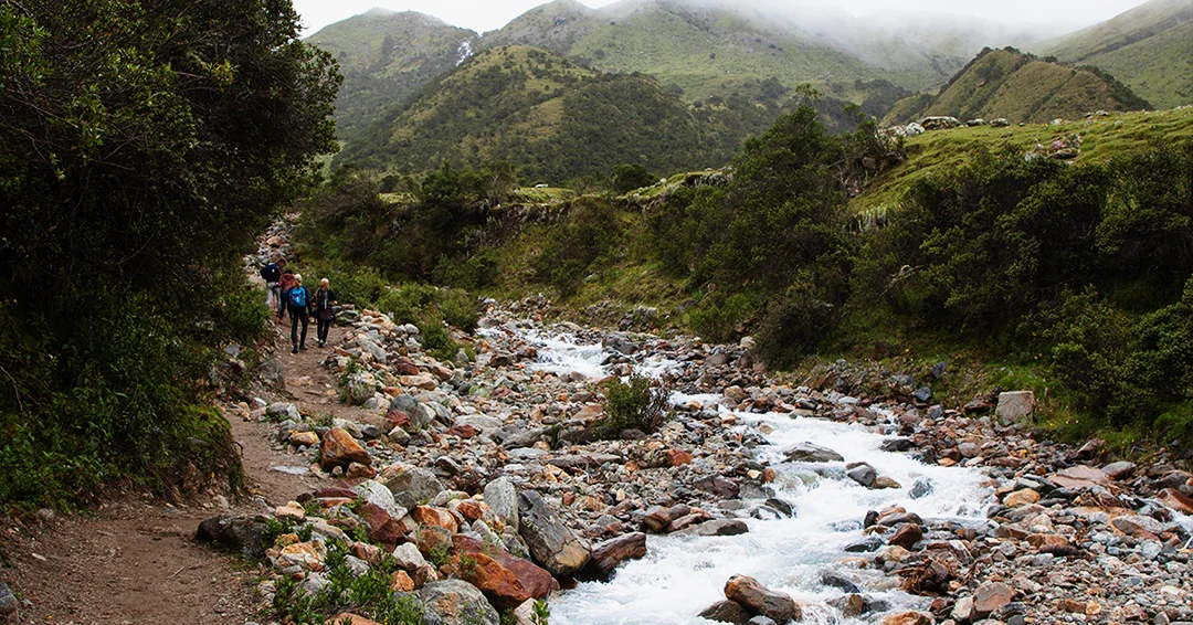 Traveler overlooking the turquoise waters of Humantay Lake in the Peruvian Andes