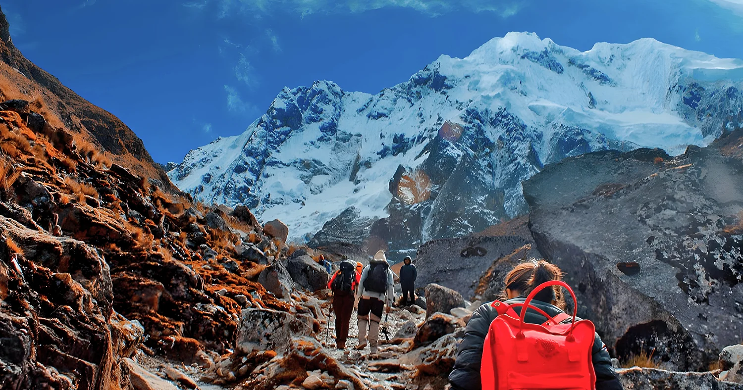 Hikers trekking through snow-capped mountains on the Salkantay route in Peru