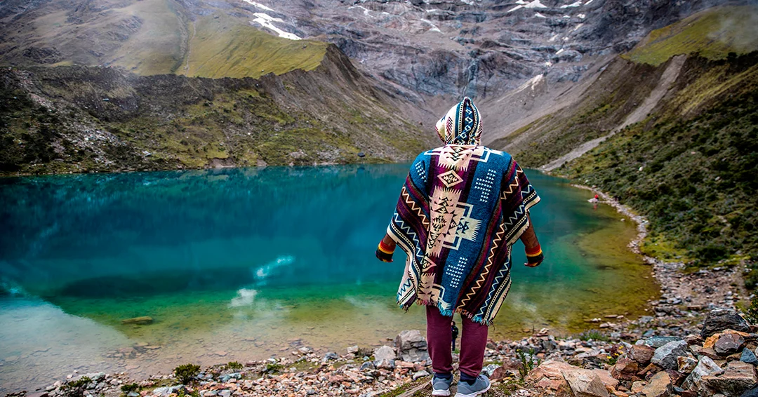 Turquoise Humantay Lake surrounded by snow-capped mountains near Cusco, Peru