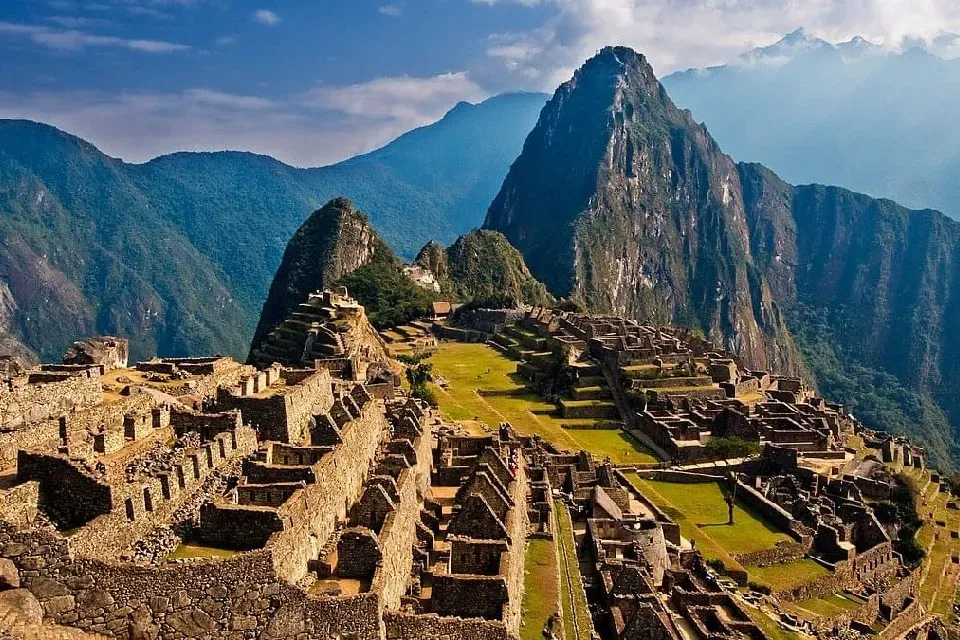Does It Snow at Machu Picchu? Machu Picchu archaeological site surrounded by green mountains and clouds in Peru.