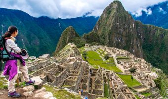 Landscape of the Machu Picchu archaeological sanctuary and surrounding lush green peaks with Peru Grand Travel