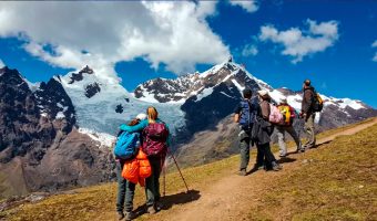 Group of hikers arriving at Machu Picchu after completing the Lares Valley Trek with Peru Grand Travel.