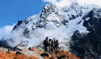 Hikers on the Salkantay Trek surrounded by snow-covered Andean mountains