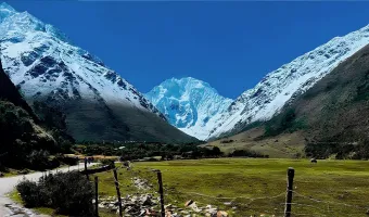 Hikers following a mountain trail beside a stream on the Salkantay Trek in Peru
