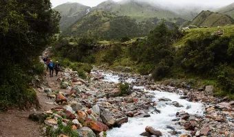 Traveler overlooking the turquoise waters of Humantay Lake in the Peruvian Andes