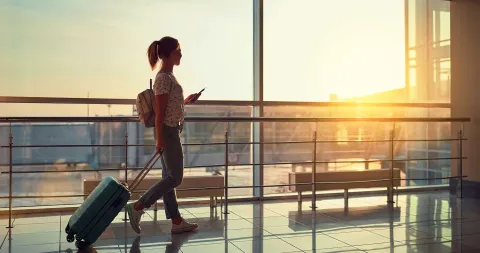 Tourist at the airport reading travel recommendations to Peru on his cell phone