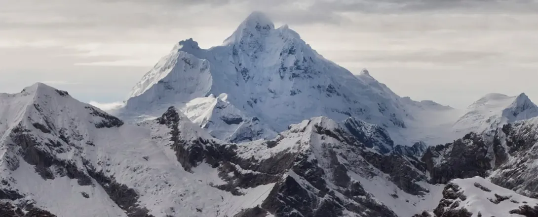 Snow in Peru, Snowy Andes Mountains Snow-covered mountains in the Peruvian Andes beneath a clear blue sky.