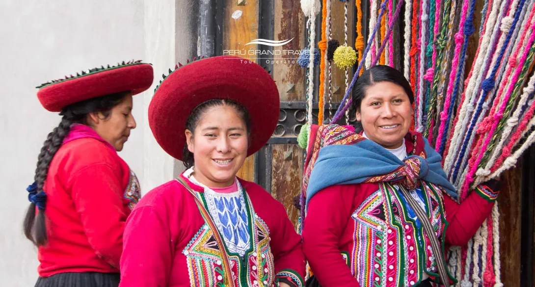 International Women’s Day – Group of Andean women artisans in Peru wearing traditional clothing and showcasing handmade textiles