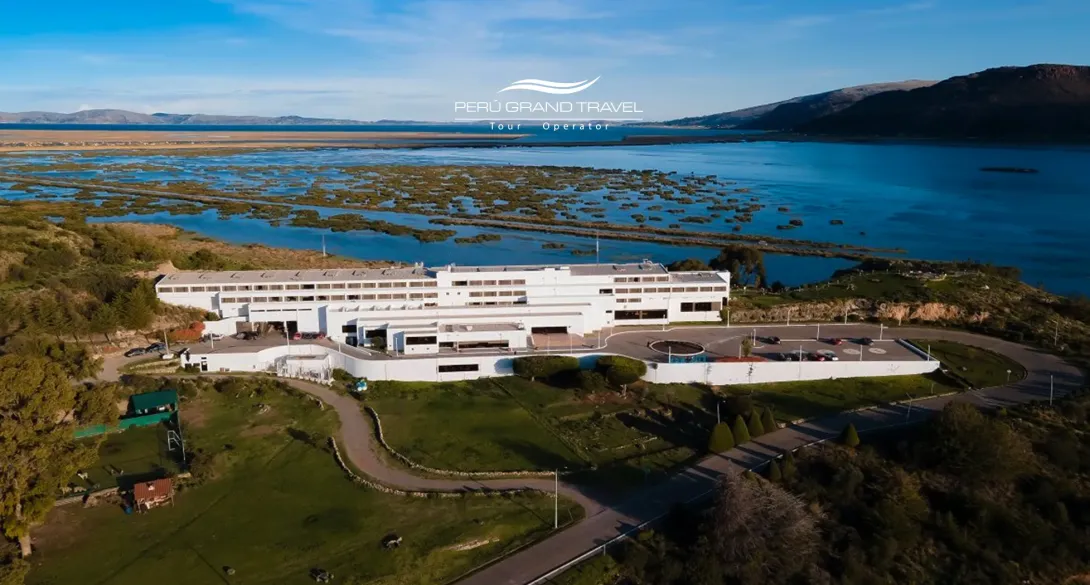 Lake Titicaca waterfront hotel in Puno, Peru, aerial view showing the property surrounded by green areas and the Andean