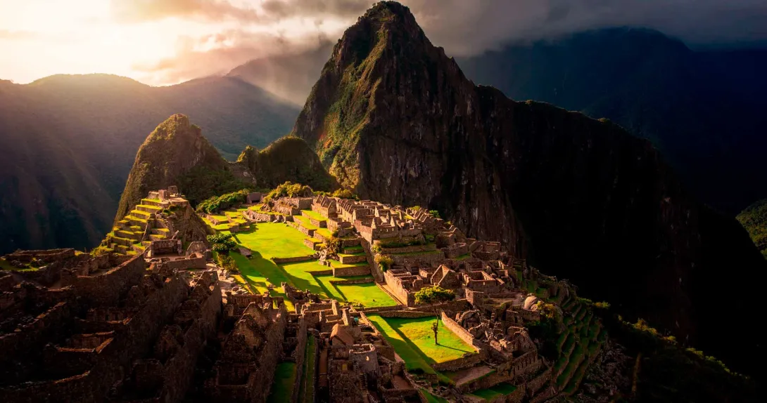 A luxury trip to Peru in Machu Picchu, overlooking the Inca buildings and the mountain behind it, shaped like an Inca.
