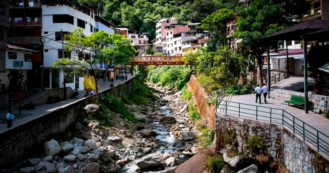 Machu Picchu town or also called Aguas Calientes, surrounded by large mountains, the Vilcanota River and lots of vegetation